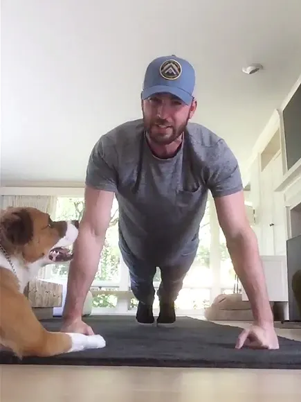 Chris Evans doing pushups with his dog
